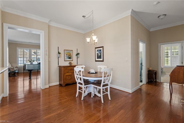 dining space with crown molding, dark wood-type flooring, and a chandelier