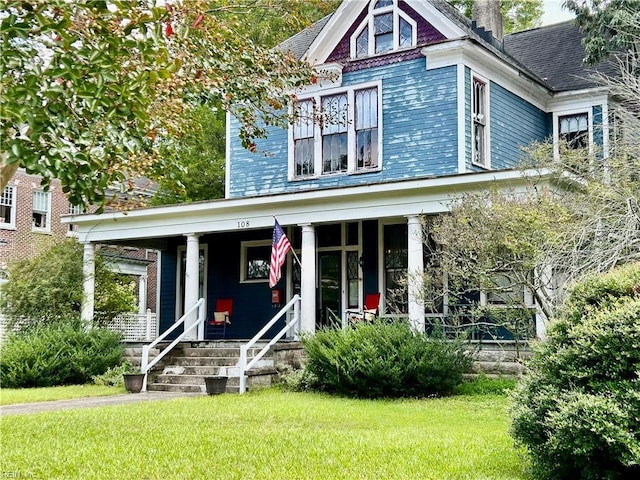 view of front of property with a front yard and a porch