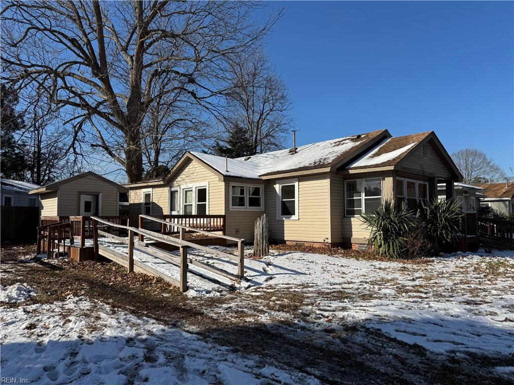 snow covered house with a deck