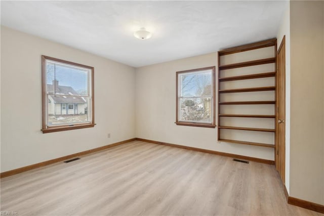 unfurnished room featuring light wood-type flooring