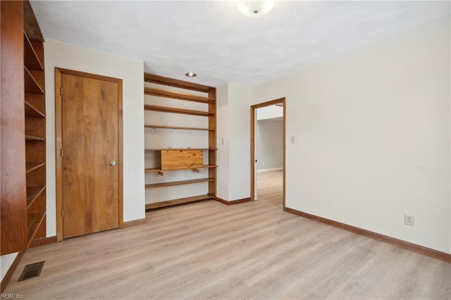 unfurnished bedroom with light wood-type flooring