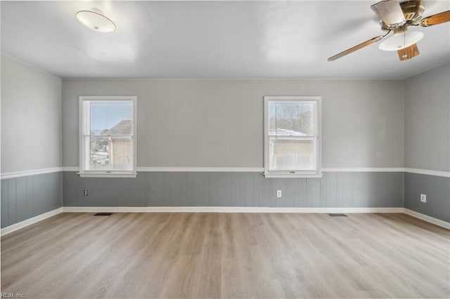 unfurnished room featuring ceiling fan and light wood-type flooring