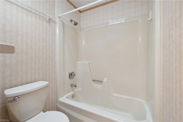 bathroom with tub / shower combination and toilet