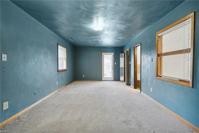 unfurnished room with light colored carpet