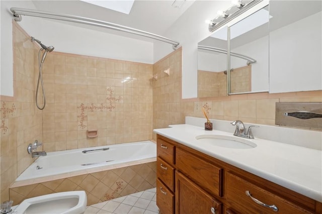 bathroom with a bidet, tile patterned flooring, backsplash, tiled shower / bath combo, and vanity