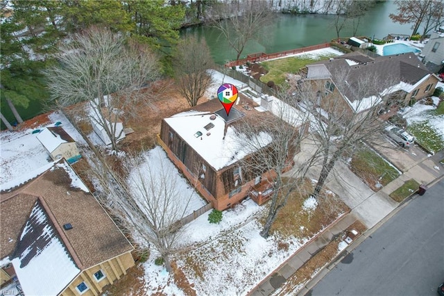 snowy aerial view with a water view