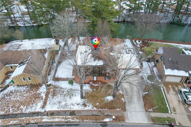 snowy aerial view with a water view