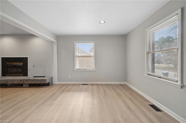 unfurnished living room featuring light wood-type flooring