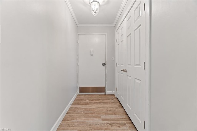 hall with light hardwood / wood-style flooring and ornamental molding