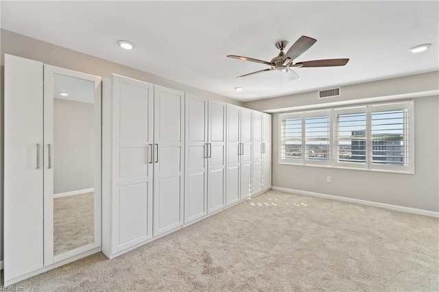 unfurnished bedroom featuring light colored carpet and ceiling fan