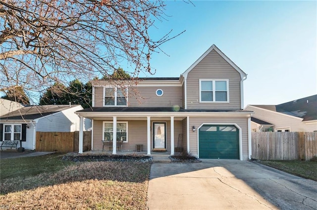 front of property featuring a garage, a front lawn, and covered porch