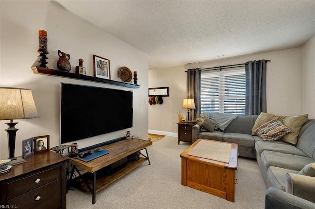 living room featuring light colored carpet and a textured ceiling