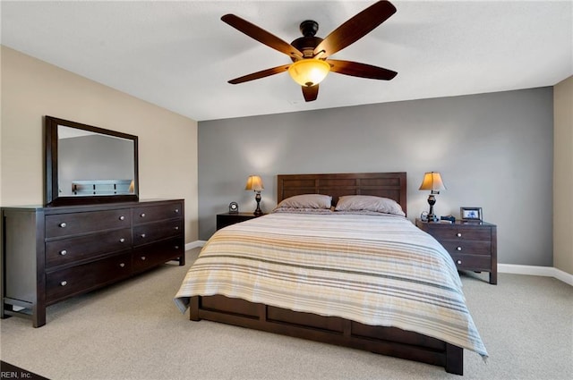 bedroom with ceiling fan and light carpet