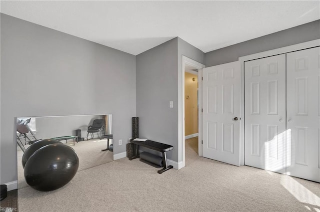 exercise room with light colored carpet