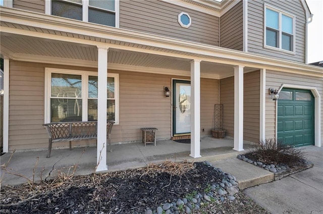 doorway to property featuring a porch and a garage