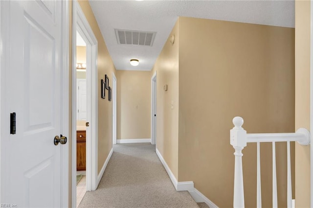 hall with light colored carpet