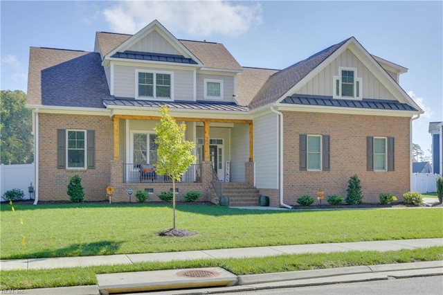 craftsman inspired home featuring a front lawn and covered porch