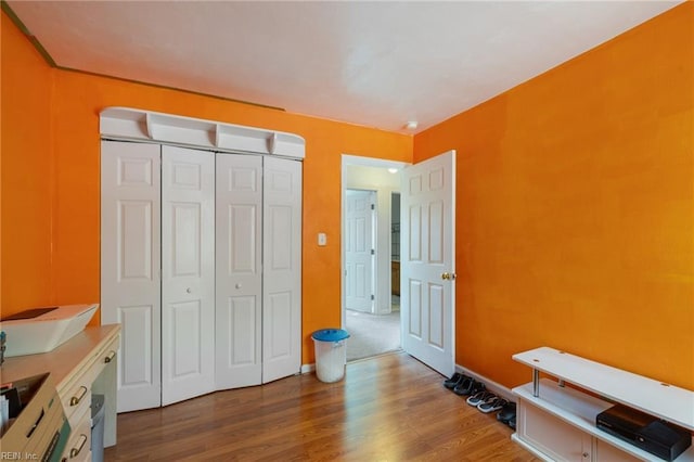 bedroom featuring hardwood / wood-style floors and a closet