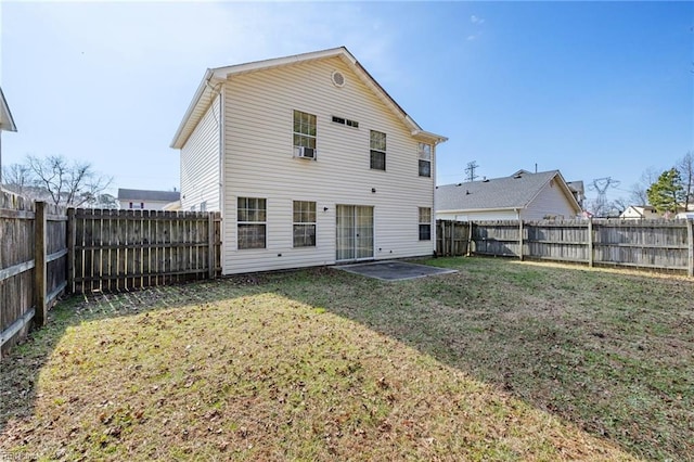 back of property with a patio area and a lawn