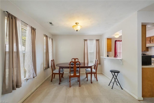 dining room with light colored carpet