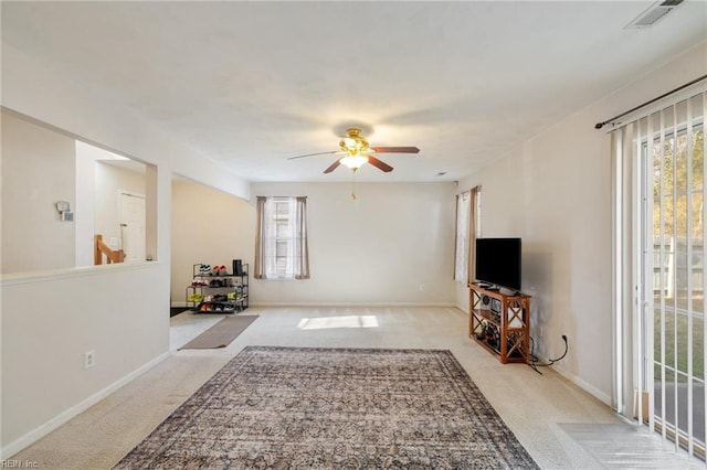 carpeted living room with ceiling fan