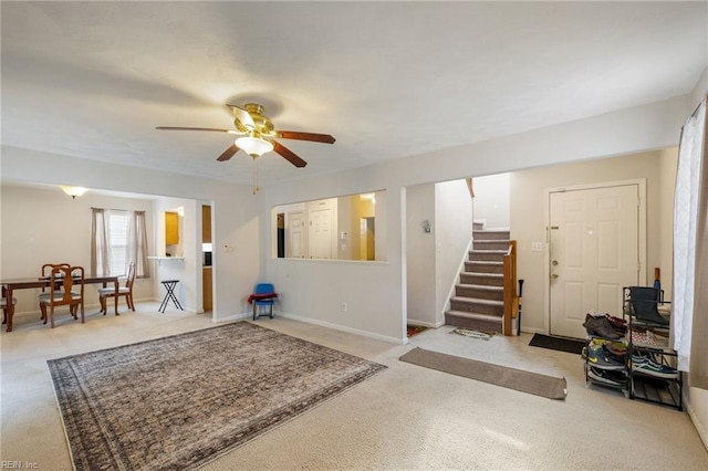 interior space featuring light colored carpet and ceiling fan