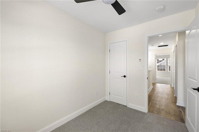 unfurnished bedroom with ceiling fan and carpet flooring