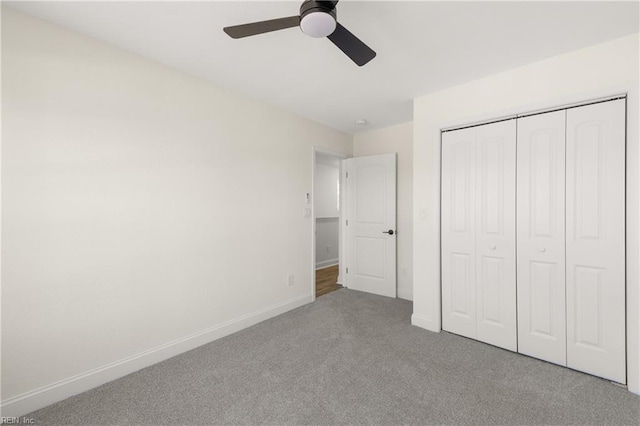 unfurnished bedroom featuring carpet, ceiling fan, and a closet