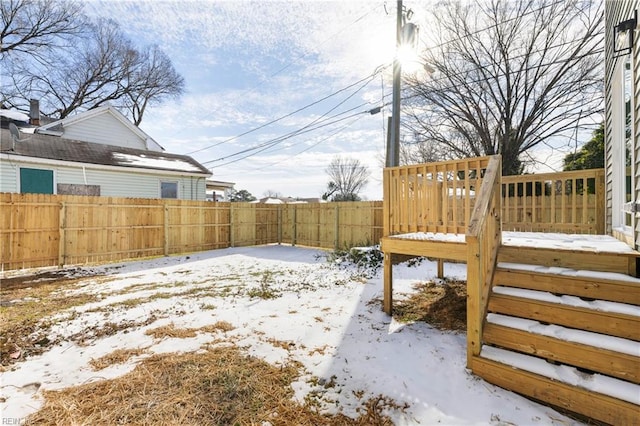 snowy yard with a wooden deck