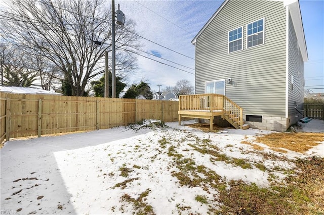 view of snow covered rear of property