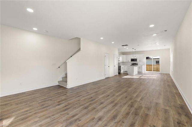 unfurnished living room featuring dark hardwood / wood-style floors