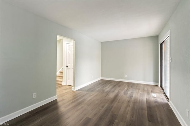 empty room featuring dark hardwood / wood-style flooring