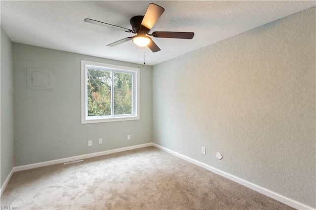 carpeted empty room featuring ceiling fan