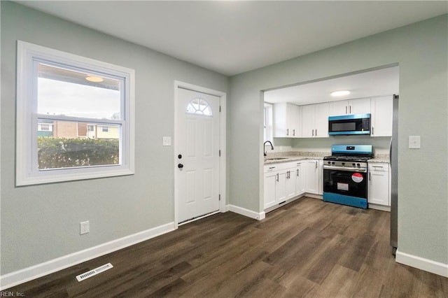 kitchen featuring white cabinetry, sink, dark hardwood / wood-style flooring, and stainless steel appliances