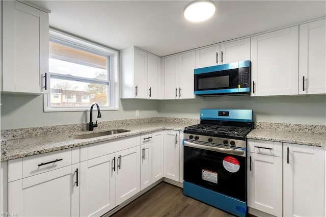 kitchen featuring white cabinetry, sink, dark hardwood / wood-style floors, and appliances with stainless steel finishes