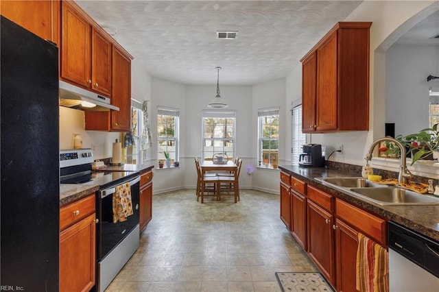 kitchen featuring pendant lighting, appliances with stainless steel finishes, sink, and a textured ceiling