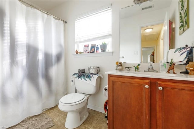 bathroom featuring vanity, toilet, and tile patterned flooring