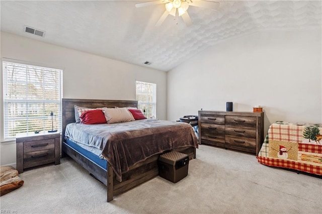 bedroom featuring lofted ceiling, multiple windows, and ceiling fan