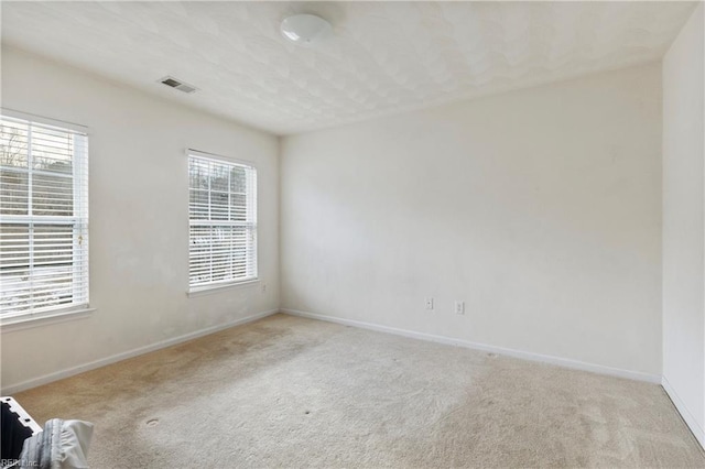 empty room with light colored carpet