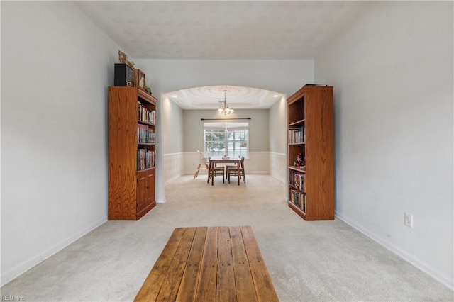 unfurnished dining area featuring light colored carpet