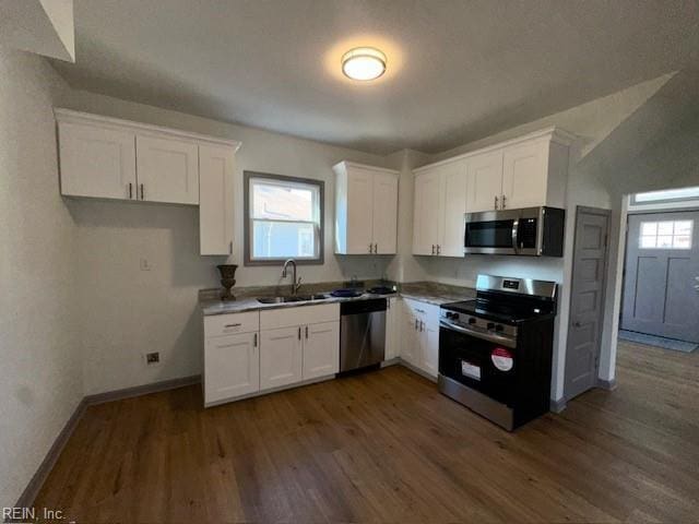 kitchen featuring dark wood-type flooring, stainless steel appliances, sink, and white cabinets