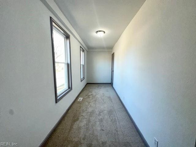 hall featuring carpet flooring