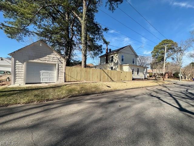 view of side of property with a garage and an outdoor structure