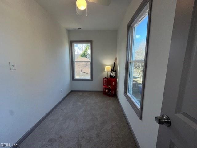 spare room with dark colored carpet