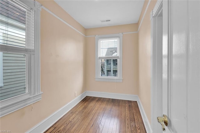 empty room with hardwood / wood-style flooring