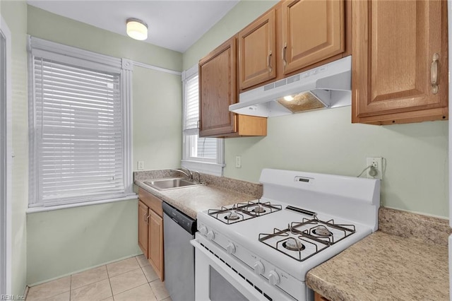 kitchen with light tile patterned flooring, stainless steel dishwasher, sink, and white range with gas stovetop