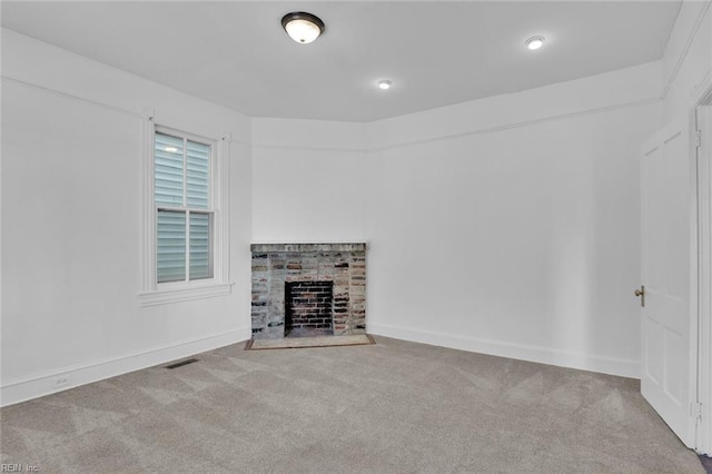 unfurnished living room with a fireplace and carpet flooring