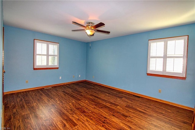 empty room featuring hardwood / wood-style flooring, ceiling fan, and a healthy amount of sunlight