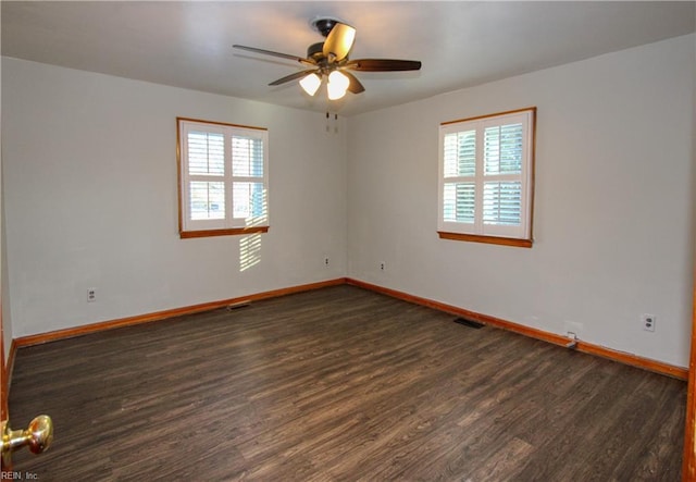 empty room with dark wood-type flooring and ceiling fan