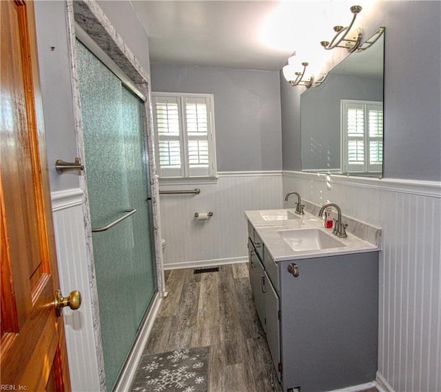 bathroom with hardwood / wood-style flooring, vanity, and walk in shower